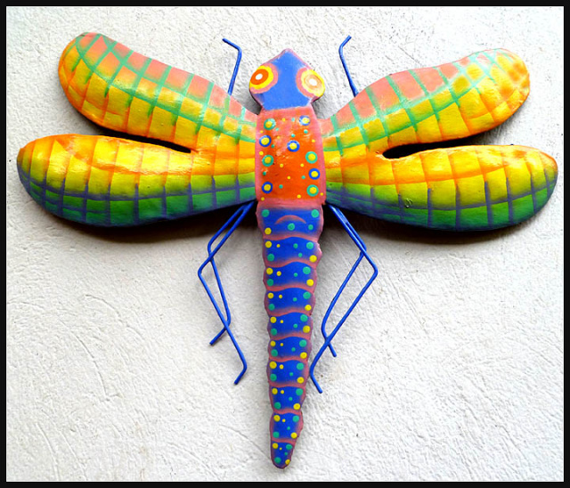 Painted metal dragonfly wall hanging.
